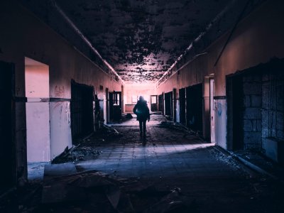 person walking on hallway of building photo