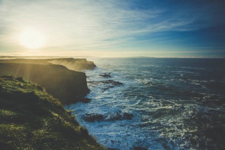 rock cliffs facing rippling body of water photo