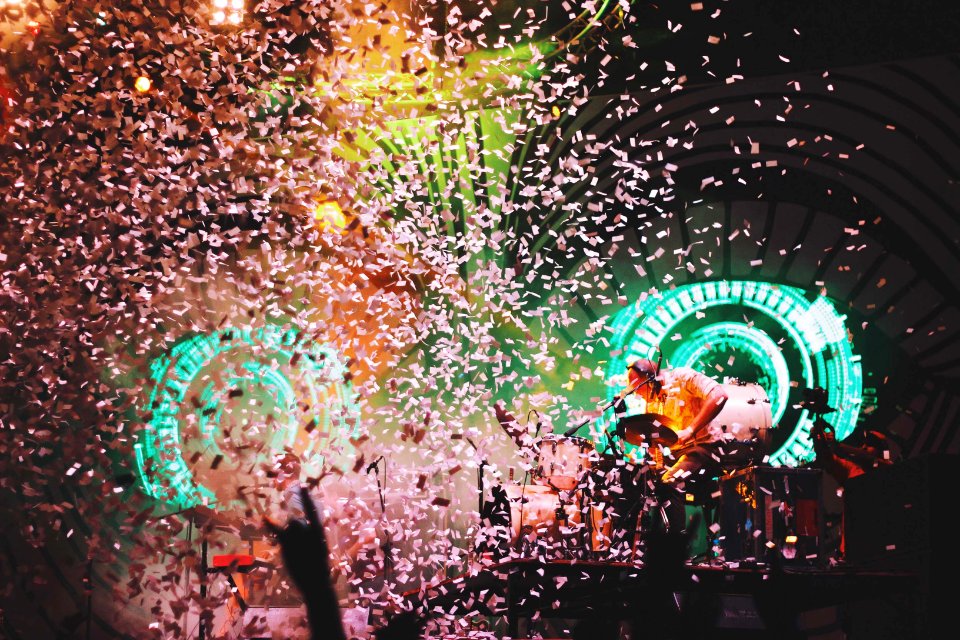 pink confetti dropping on lighted stage photo