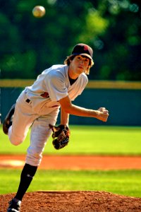 baseball pitcher throwing some fast ball pitch photo
