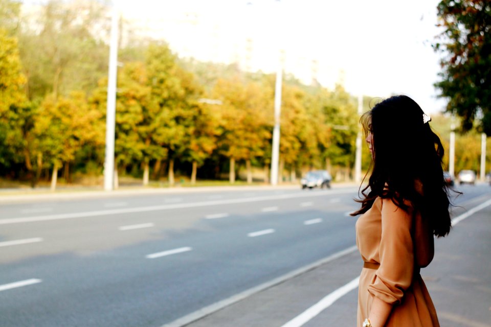 woman standing beside road