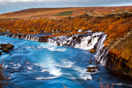 landscape photography of waterfalls surround by brown fiels photo