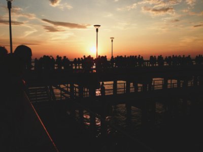silhouette of people on bridge