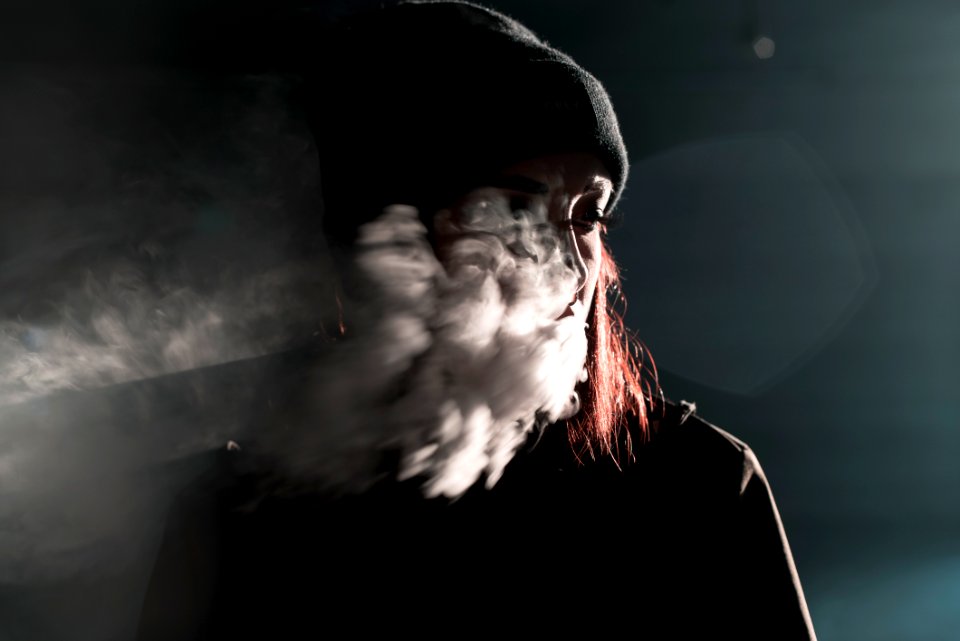 portrait photography of person blowing smoke