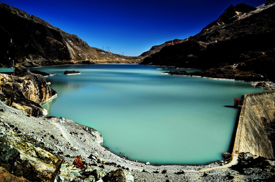 dam within mountain range during daytime