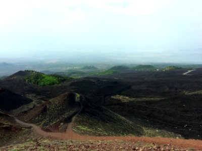 aerial photo of brown hills under cloudy sky during daytime photo