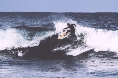 man surfboarding during daytime photo