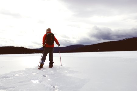 man standing on snow covered surface photo