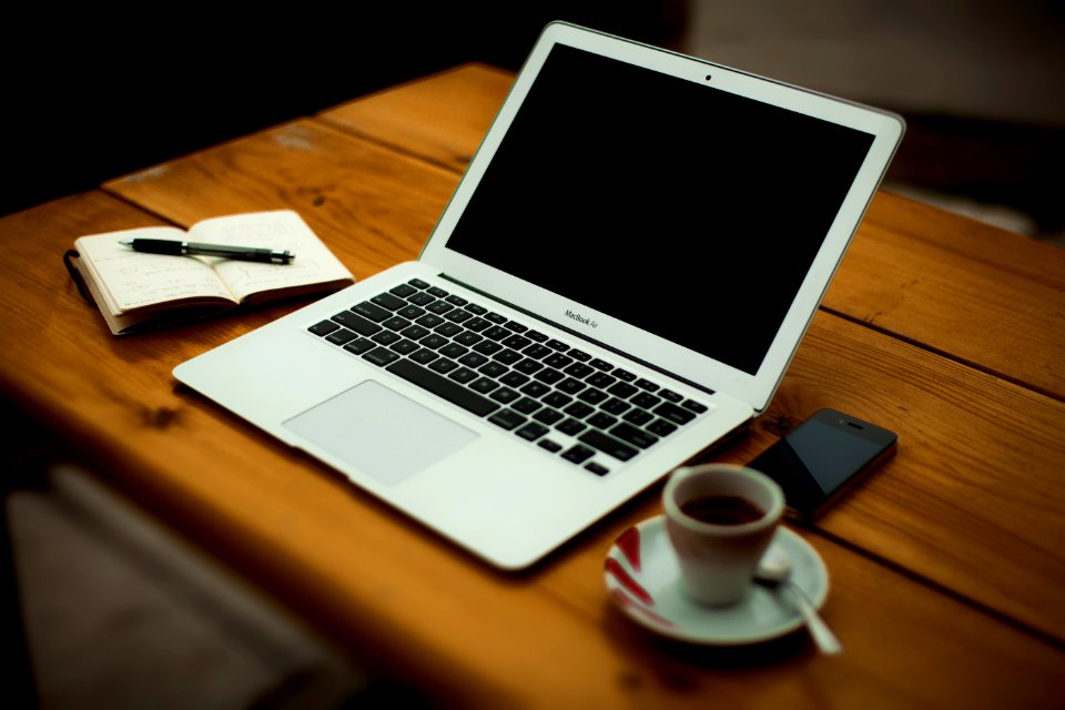 MacBook Air on brown wooden table