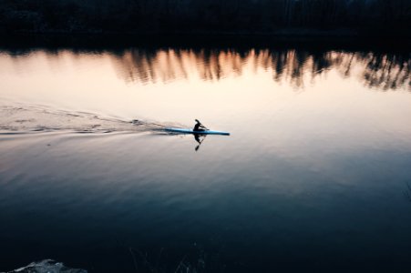 person using boat on lake during daytime photo