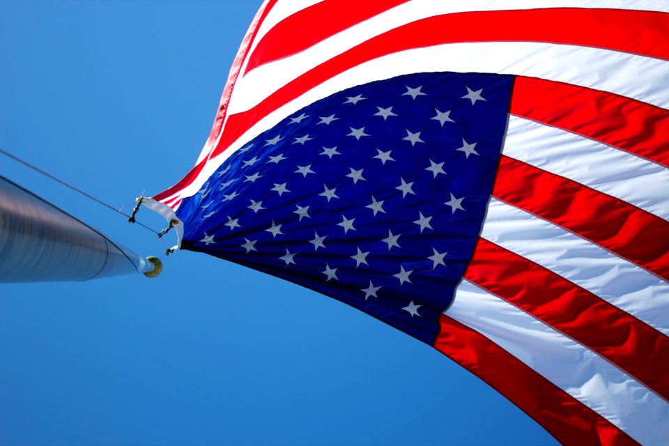 USA flag waving under blue sky