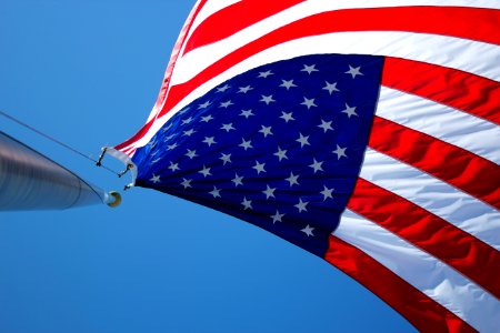 USA flag waving under blue sky