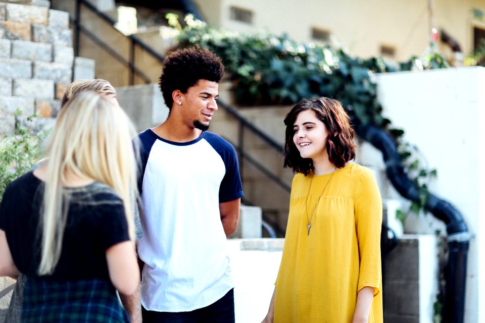 women and man talking outside the building photo