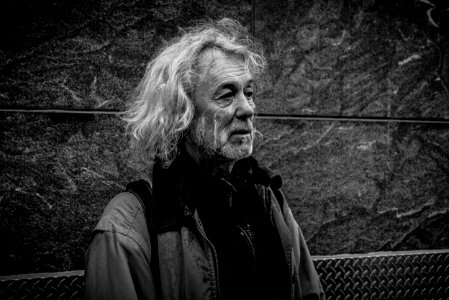 grayscale photo of long-haired man photo