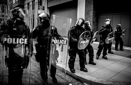 policemen holding clear fiber glass shield photo