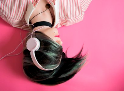 woman covering her hair and wearing headphones photo