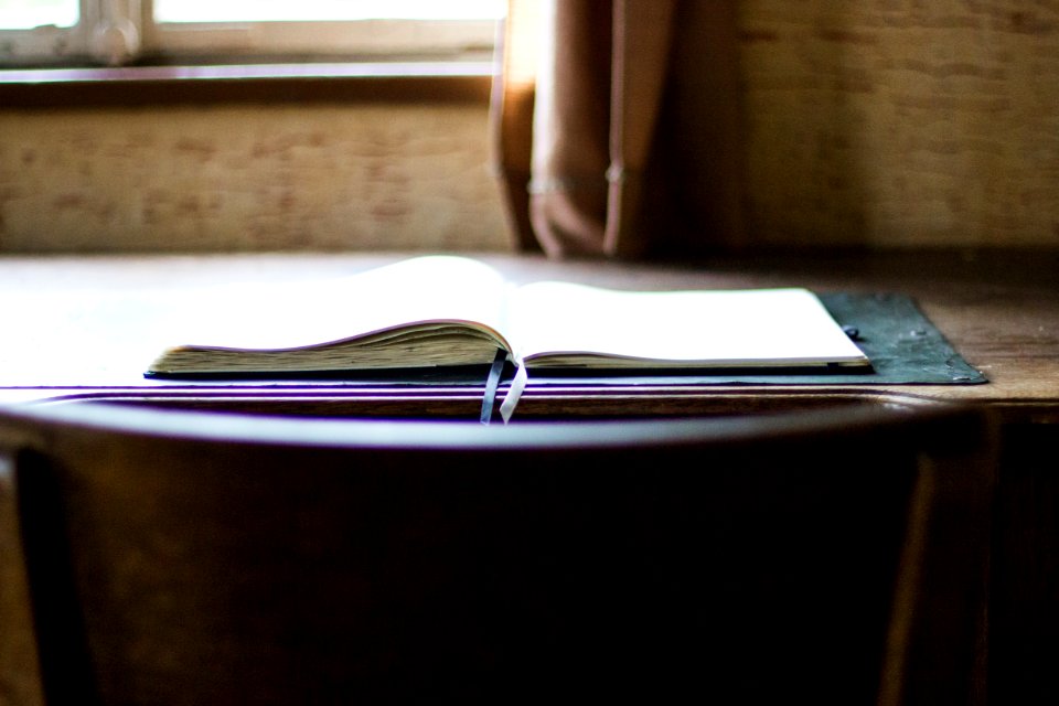 open book on brown wooden table