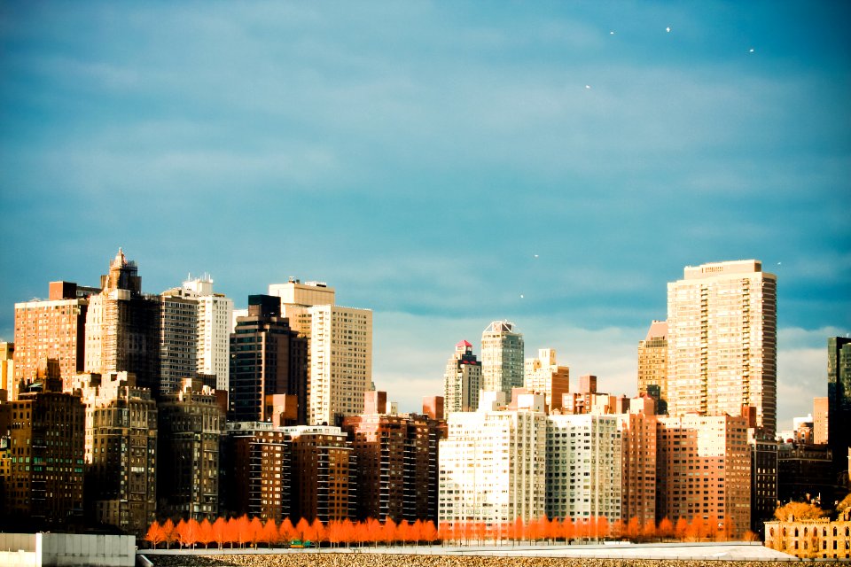 concrete buildings under cloudy sky photo