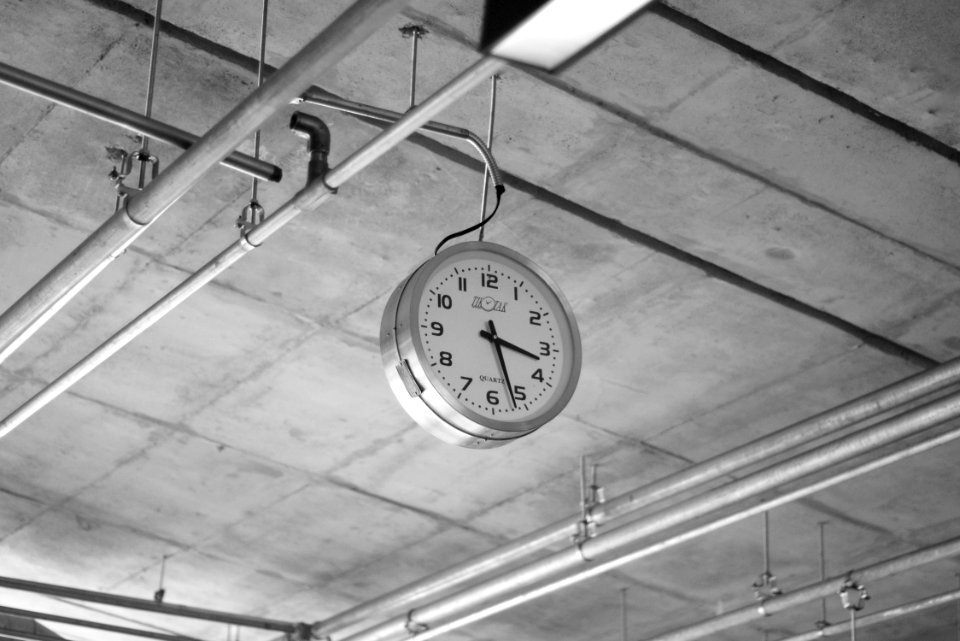 round grey stainless steel analog clock displaying 3:22