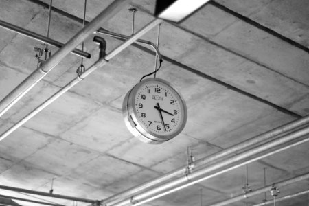 round grey stainless steel analog clock displaying 3:22 photo