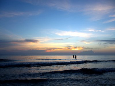 silhouette photography of two person in body of water photo