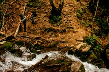 two person hiking in the mountain terrain photo