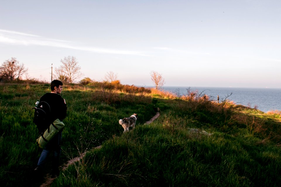 man walking on pathway nearby sea