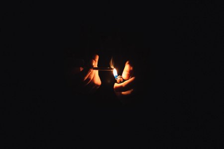 person lighting cigarette photo