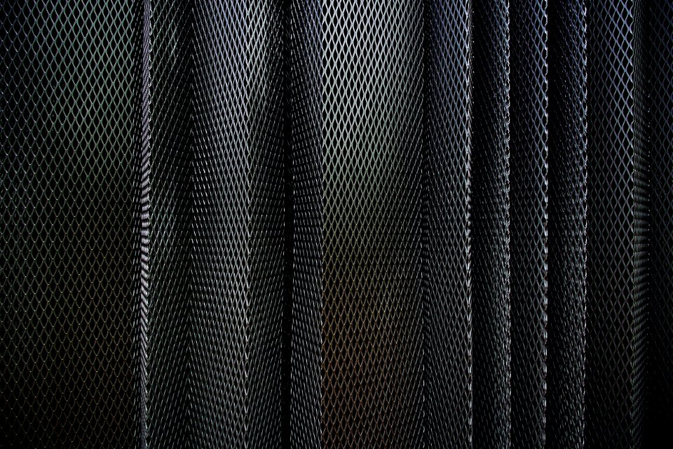 A metal criss-cross grid in undulating layers