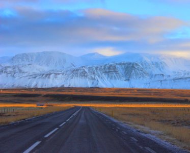 gray asphalt road in front of snow mountains photo