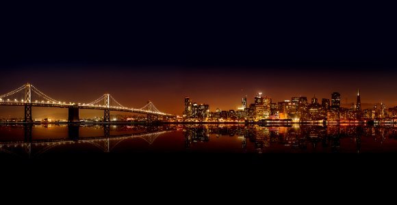 cityscape photography of lighted city with bridge photo