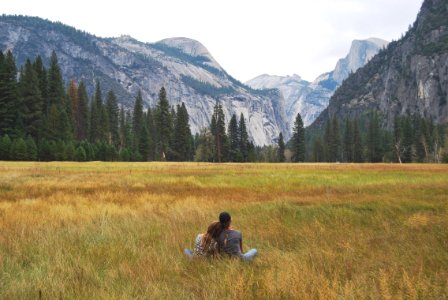 two person sitting on grass field photo