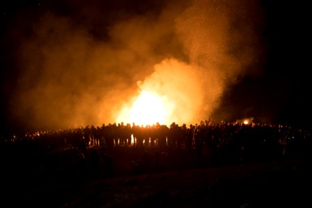 people gathered near bonfire during nighttime photo