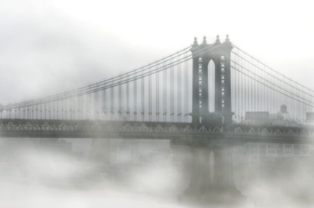 fog over Brooklyn Bridge during daytime photo