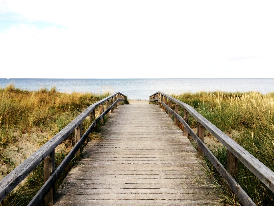 photo of gray wooden bridge