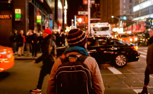 woman crossing highway during nighttime photo