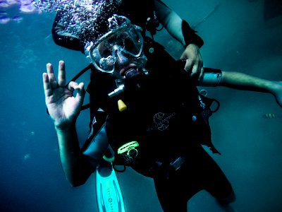 person wearing diving suit under water photo