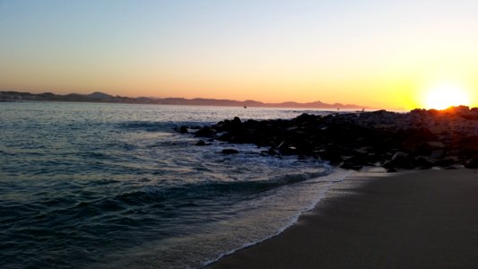 beach with rocks during golden hour