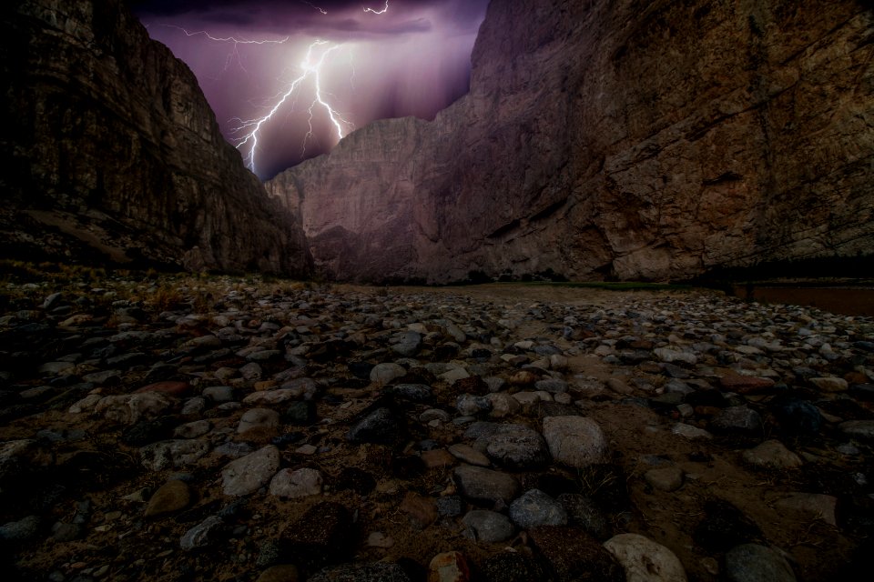 lightning hitting brown rock mountain