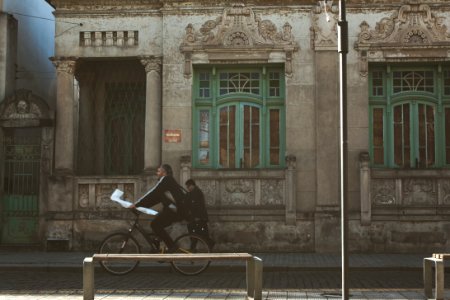 man riding bicycle on the street during daytime photo