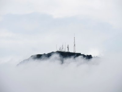 Radio towers on top of a cloud-shrouded mountain in Brazil photo