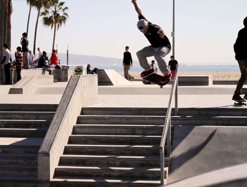 person riding skateboard performing stunt over stairs