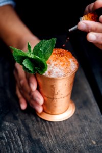 brass-colored cup filled with crushed ice with mint