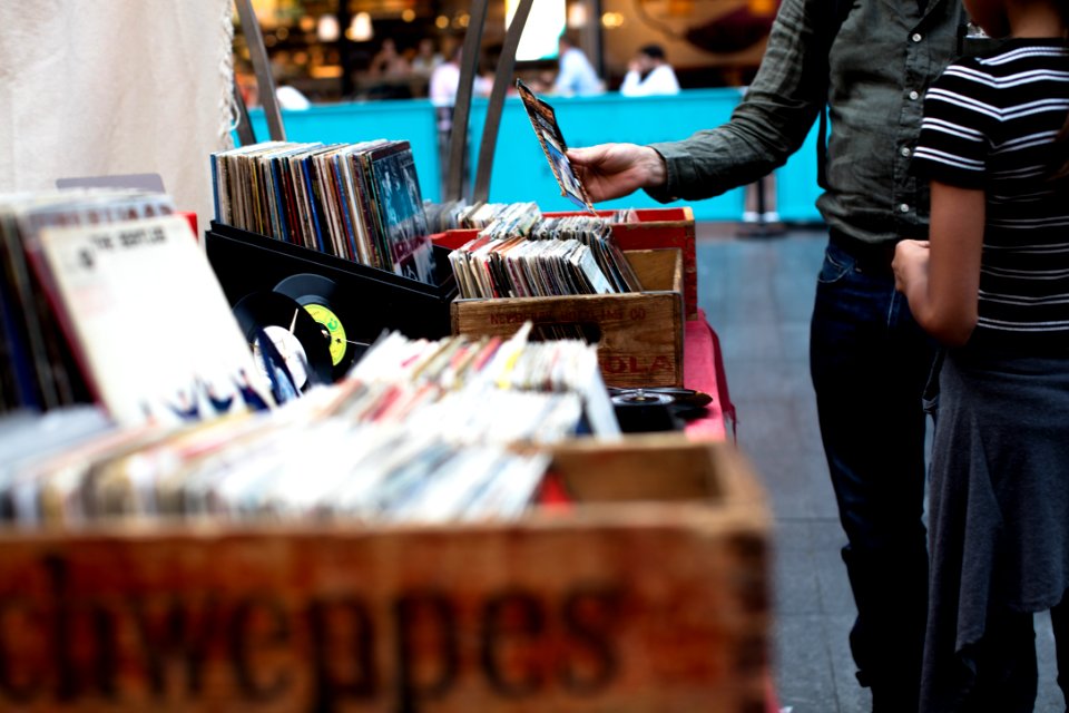 men standing in front of vinyl record sale