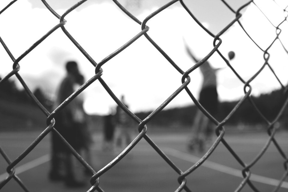 grayscale photo of cyclone fence