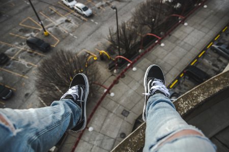 man sitting on rooftop selective focus photography photo