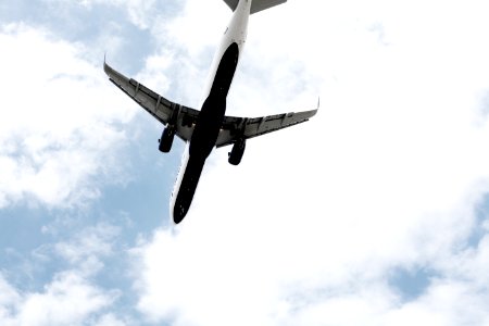 white air plane under the clouds photo