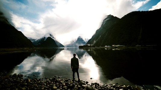 person standing in front of body of water photo