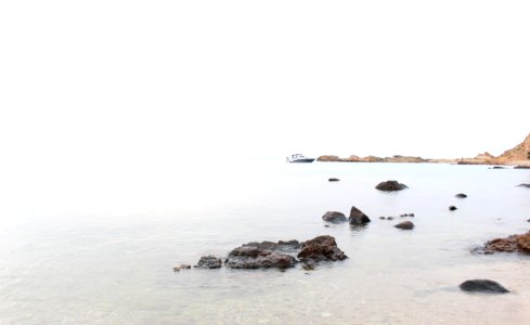 body of water near rocks at daytime photo