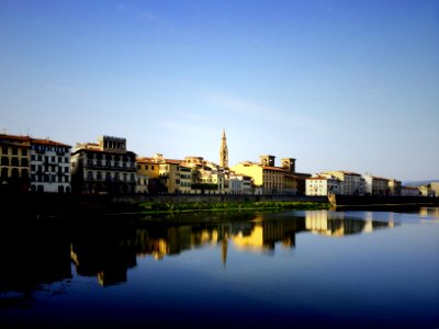 beige buildings near large body of water